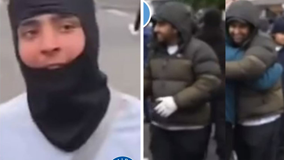 One of the men is wearing a hood partially obscuring his face, the other a dark puffer jacket with the hood pulled up.