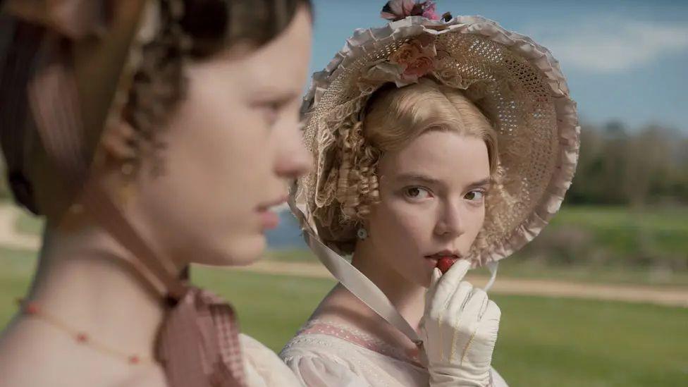 anya taylor-joy playing emma in regency dress next to mia goth playing harriet smith