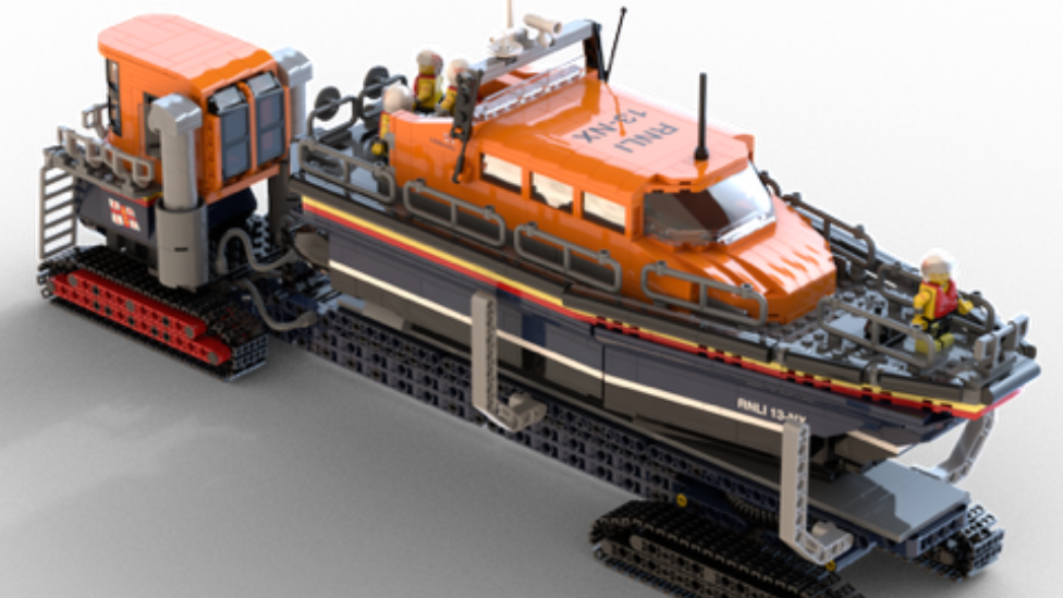 A LEGO version of the Shannon Class lifeboat. It has a green cabin above a blue hull. It is on a long mobile slipway.