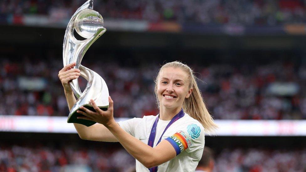 Leah Williamson holds Euro 2022 trophy aloft