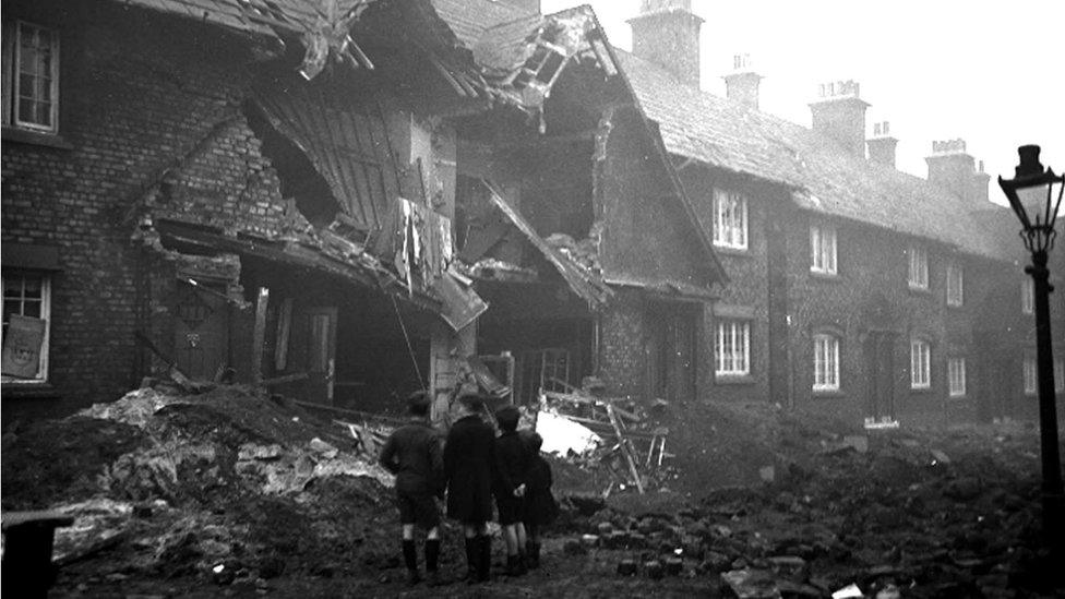 Children inspect bomb damage to houses in Liverpool