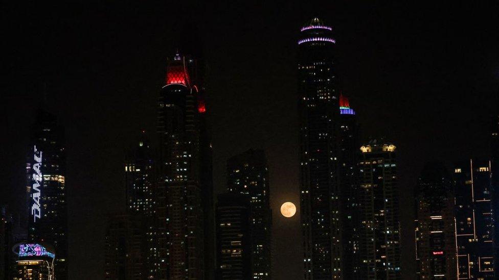 Here the supermoon is seen rising above the skyscrapers in Dubai.