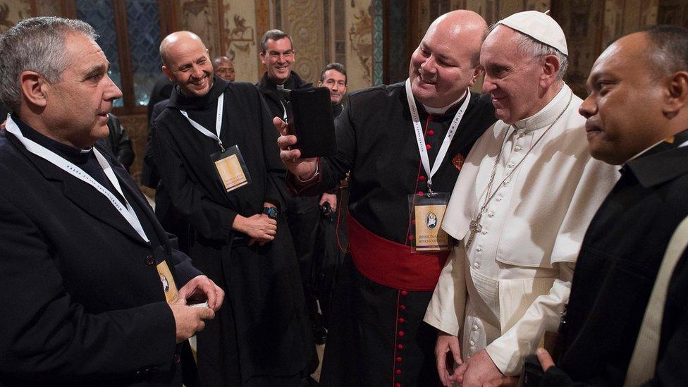 'Missionaries of Mercy' pose for a selfie with the Pope