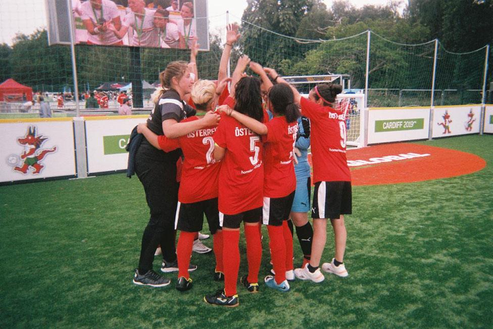 A football team huddle on the pitch