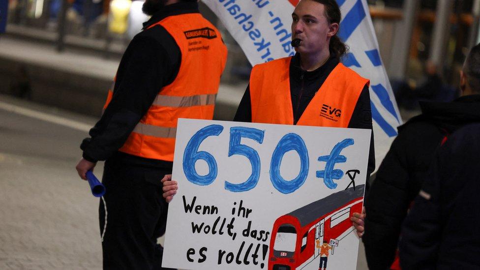 A transport worker protests at Munich's main train station