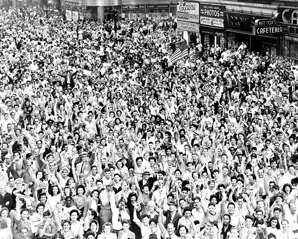 A crowd cheers in Times Square in New York