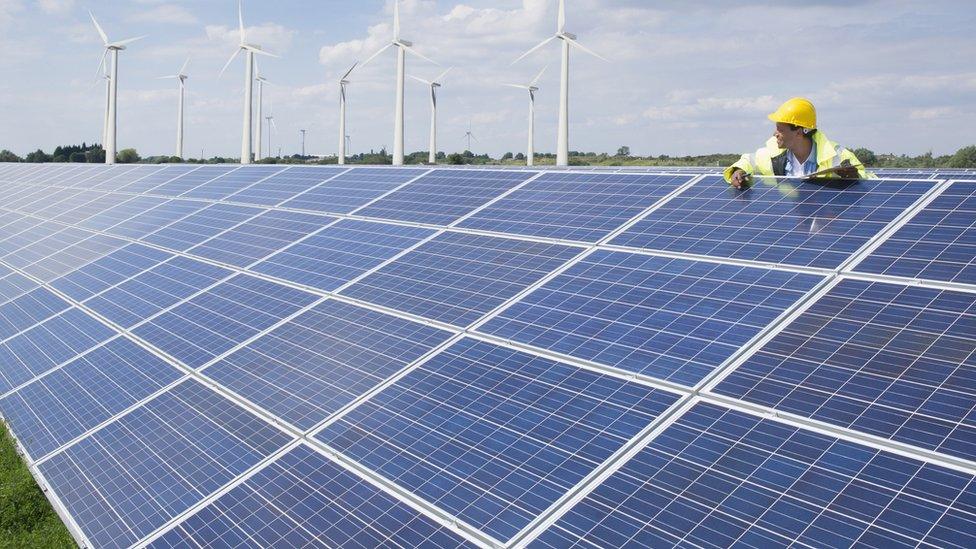 A man beside solar panels