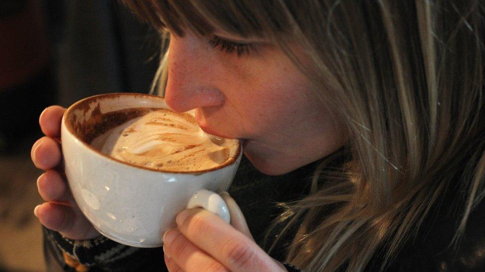 Woman drinking a cappuccino in Berlin, 24 Jan 11