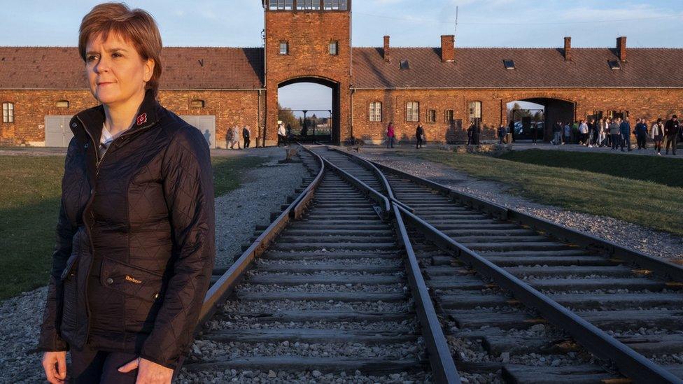 Nicola Sturgeon standing at the camps notorious railway station