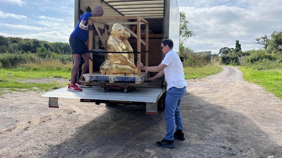 The chocolate gorilla being offloaded from a van