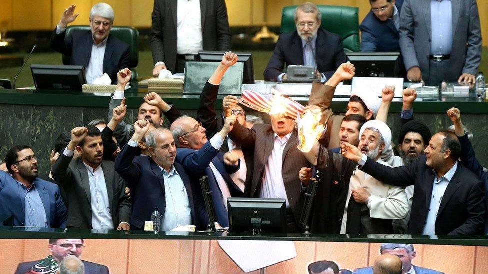 Iranian politicians burning the US flag