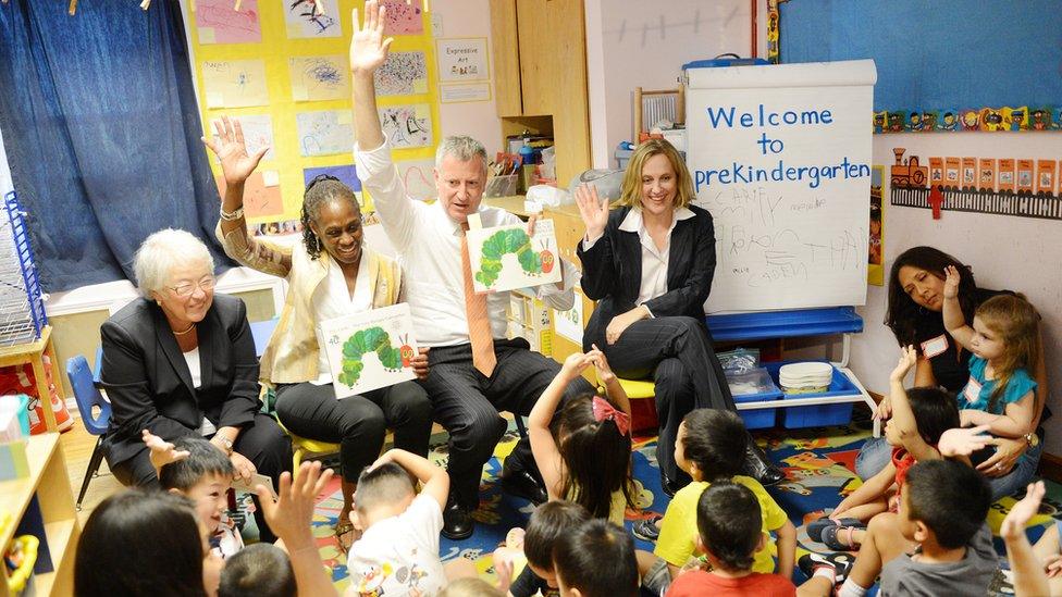 New York Mayor Bill de Blasio (Center-R), along with Schools Chancellor Carmen Farina (L), First Lady Chirlane McCray (C), and Queens Borough President Melinda Katz (R), visits Pre-K classes at Home Sweet Home Children's School in Queens on the first day of NYC public schools, September 4, 2014