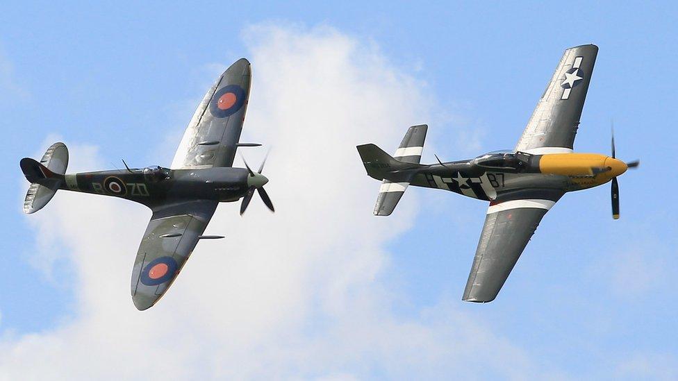 A USAF P-51 Mustang (right) leads a fly by of vintage military airplanes during Goodwood Revival 2010