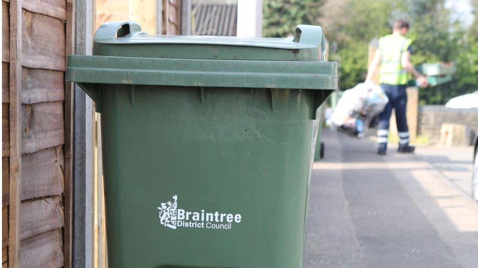 A green garden waste collection bin