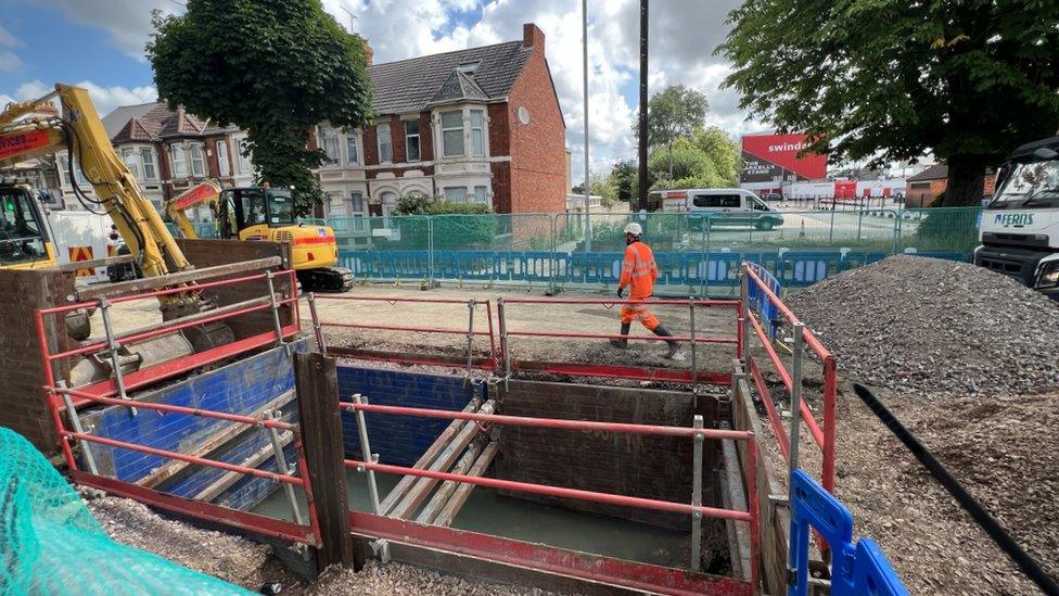 Engineers reinforce excavated three metre hole to access pipe