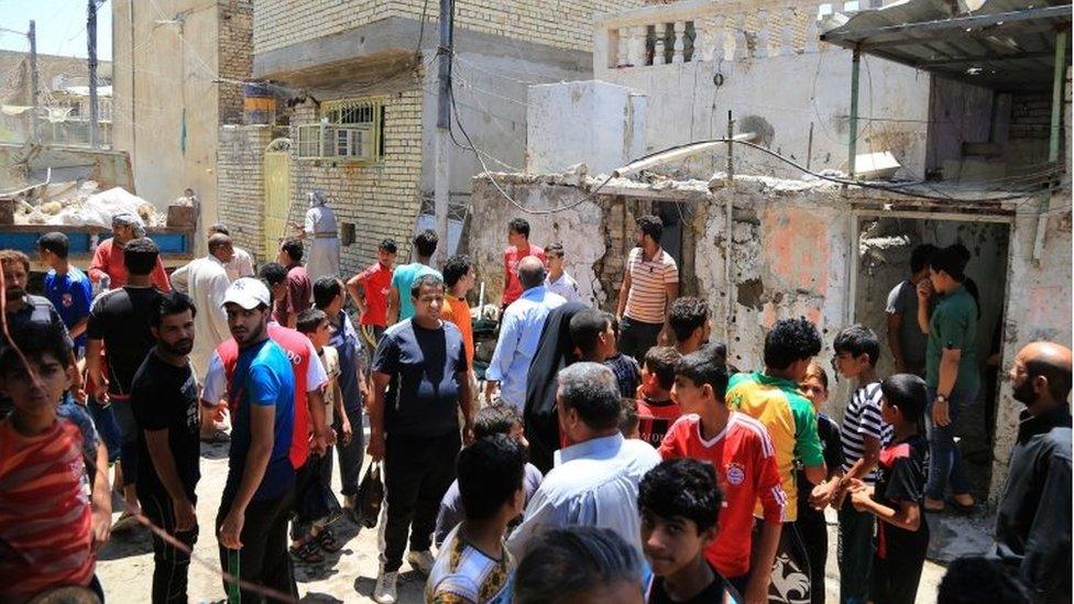 People inspect the aftermath of a bomb attack in the Sadr city district, Baghdad, Iraq (May 30 2016)