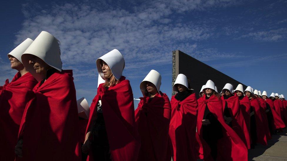 Activists dressed as handmaids