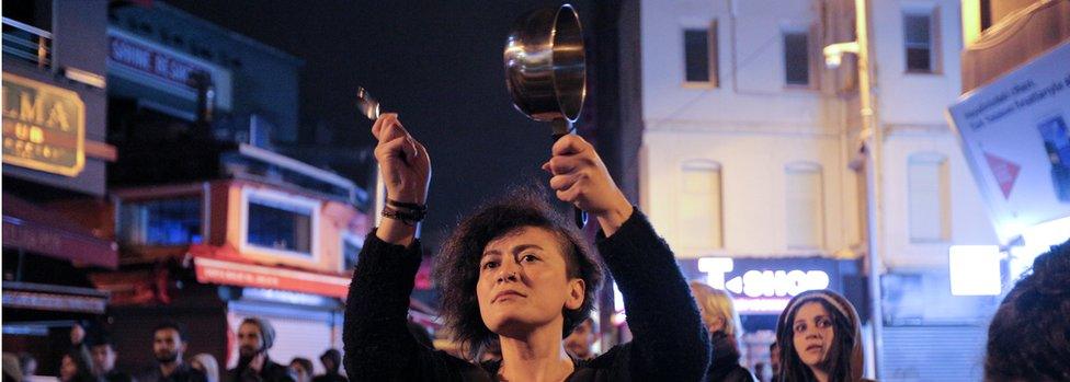 A woman in Istanbul bangs a saucepan to protest against the referendum result