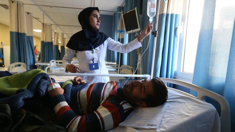 An Iranian nurse tends to a man wounded in a stampede in the southeastern city of Kerman in January 2020.