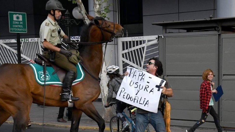 An anti-Pope protester is confronted by mounted police in Santiago, Chile. Photo: 15 January 2018