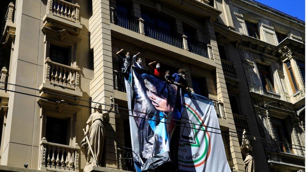 Lawyers shout slogans as they hold a portrait of Ebru Timtik, a Turkish lawyer who died while she was on hunger strike for 238 days