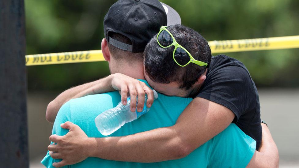 Supported by a friend, a man weeps for victims of the mass shooting just a block from the scene in Orlando, Florida, on June 12, 2016.