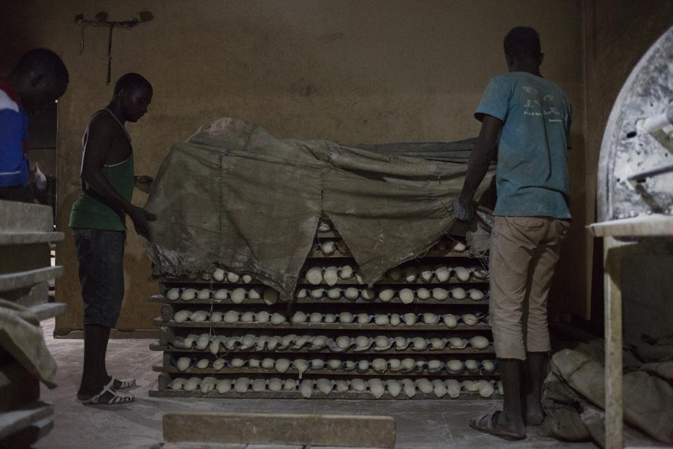 Workers at Buru Niouman Bakery in Bamako, Mali unveil racks of dough that are ready to be baked. 5 February 2019.