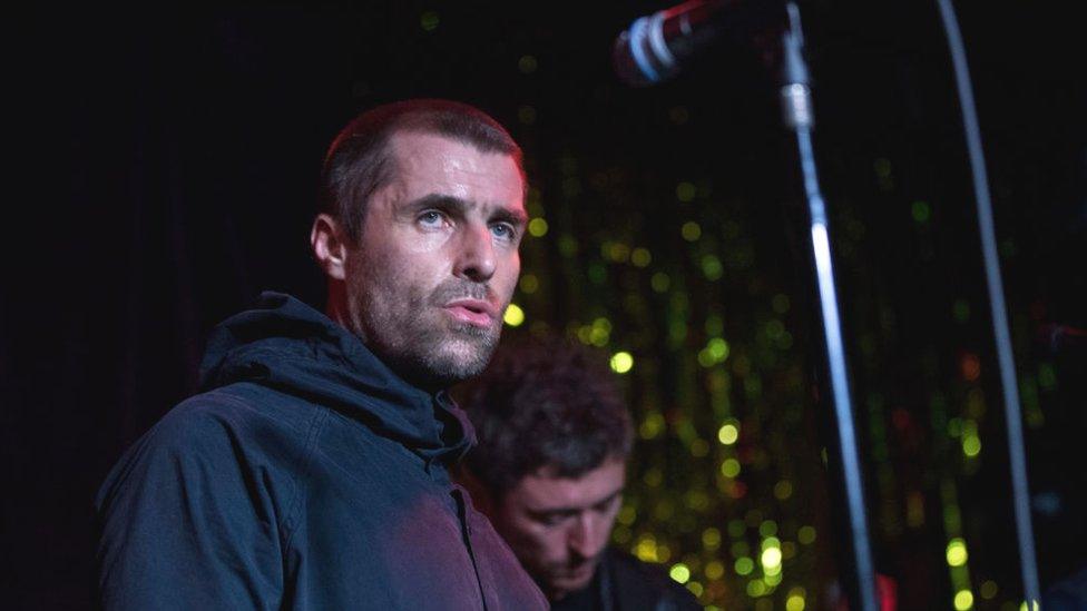 Liam Gallagher performing on stage