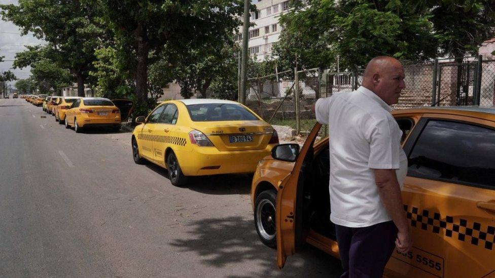 Taxi driver Daniel Martinez waits in line for the arrival of a fuel tank truck in Havana, Cuba, 5 April 2023.