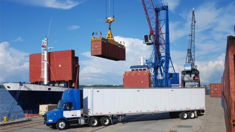 Container being lifted from a ship to a lorry