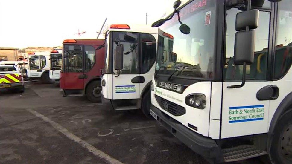 A row of recycling vehicles parked alongside each other