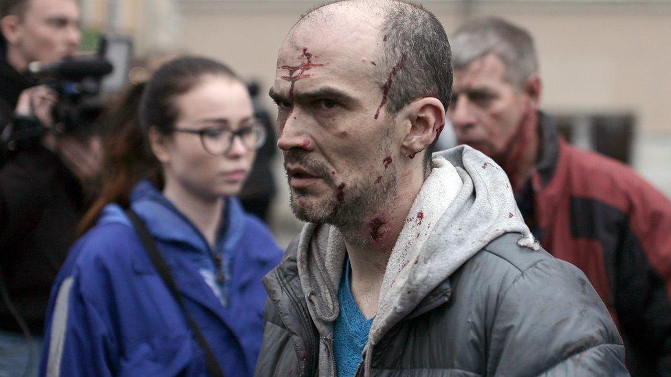 An injured man outside Tekhnologichesky Institut metro station in St Petersburg