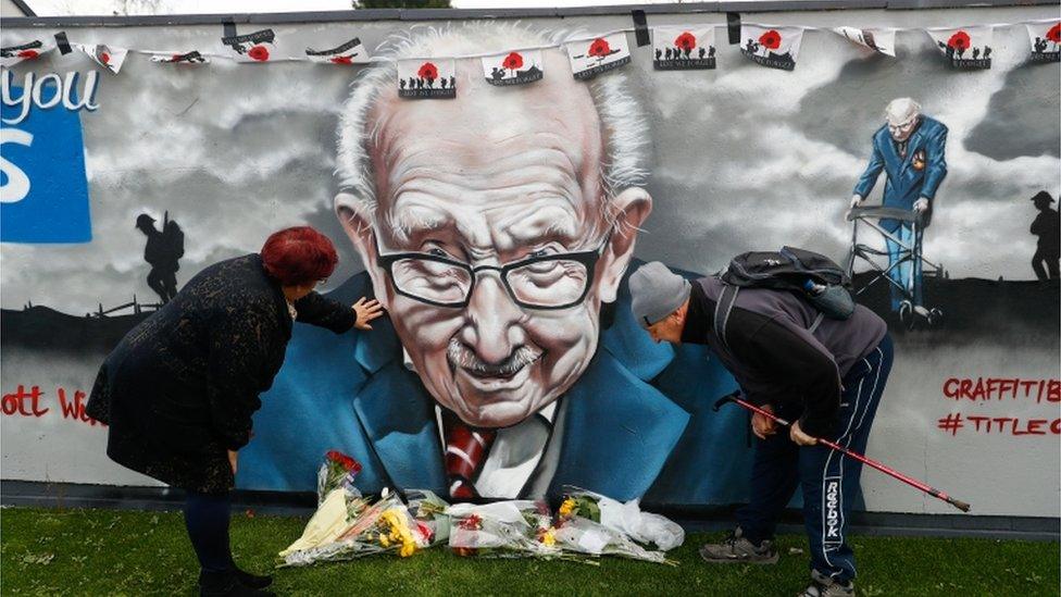 People view a mural of late record-breaking centenarian Captain Tom Moore, in Two Gates, Tamworth