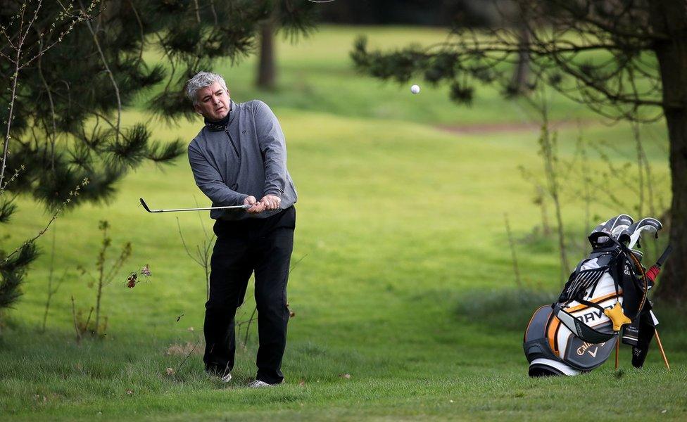 A golfer hits a golfball