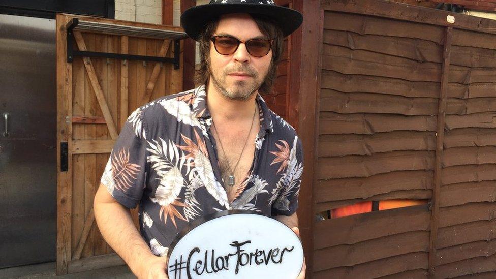 Gaz Coombes with #CellarForever sign