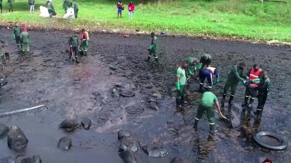 Workers trying to clean up the oil from the spill