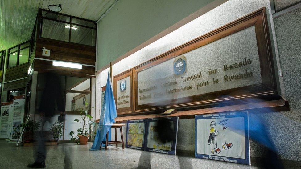 People walk inside the International Criminal Tribunal for Rwanda (ICTR) in Arusha