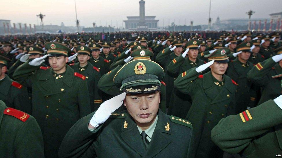 A detachment of the Chinese People's Armed Police responsible for the security of Tiananmen Square and the Forbidden City gather for a ceremony to mark the handover of guard duties on Tiananmen Square in Beijing on November 23, 2009