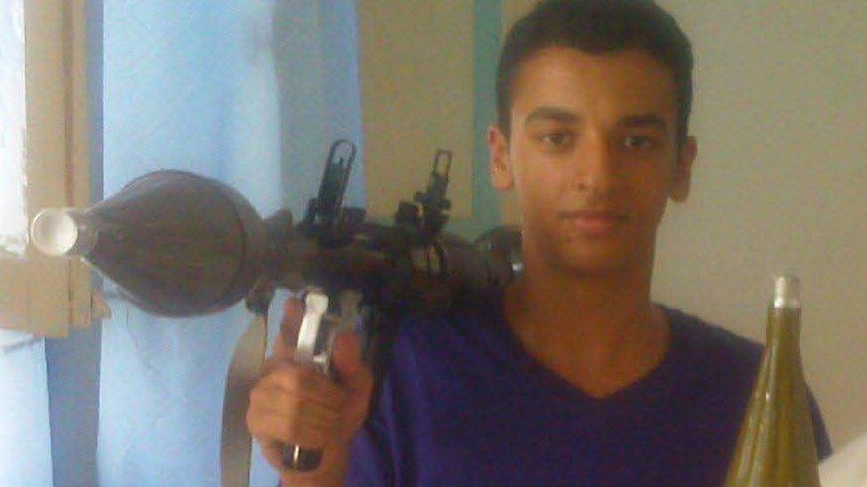 Ismail Abedi carrying a rocket launcher