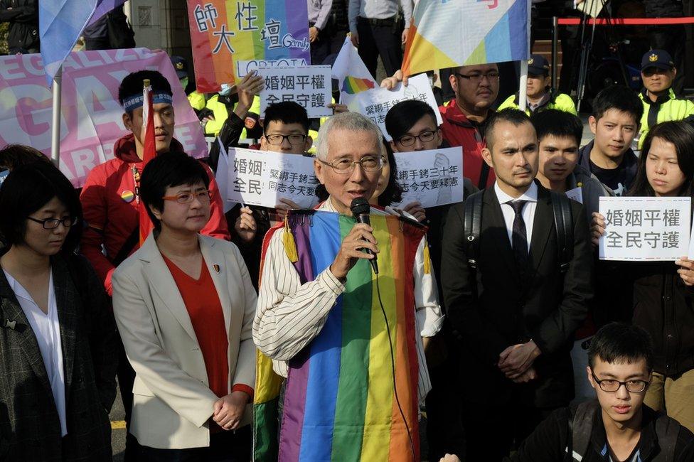 Veteran gay rights activist Chi Chia-wei (C) speaks to the press with his supporters in front of the Judicial Yuan in Taipei on 24 March 2017.