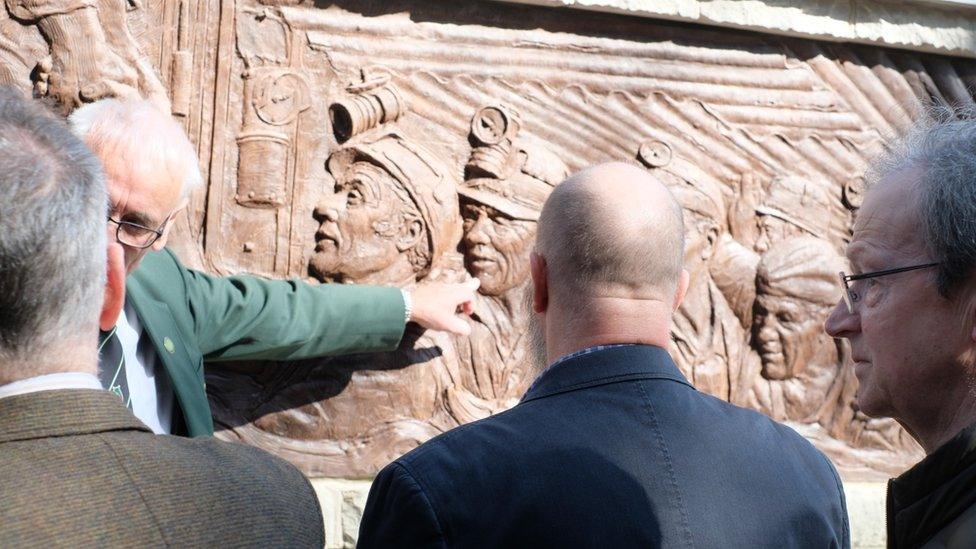 Robert Morgan point out his father in the memorial