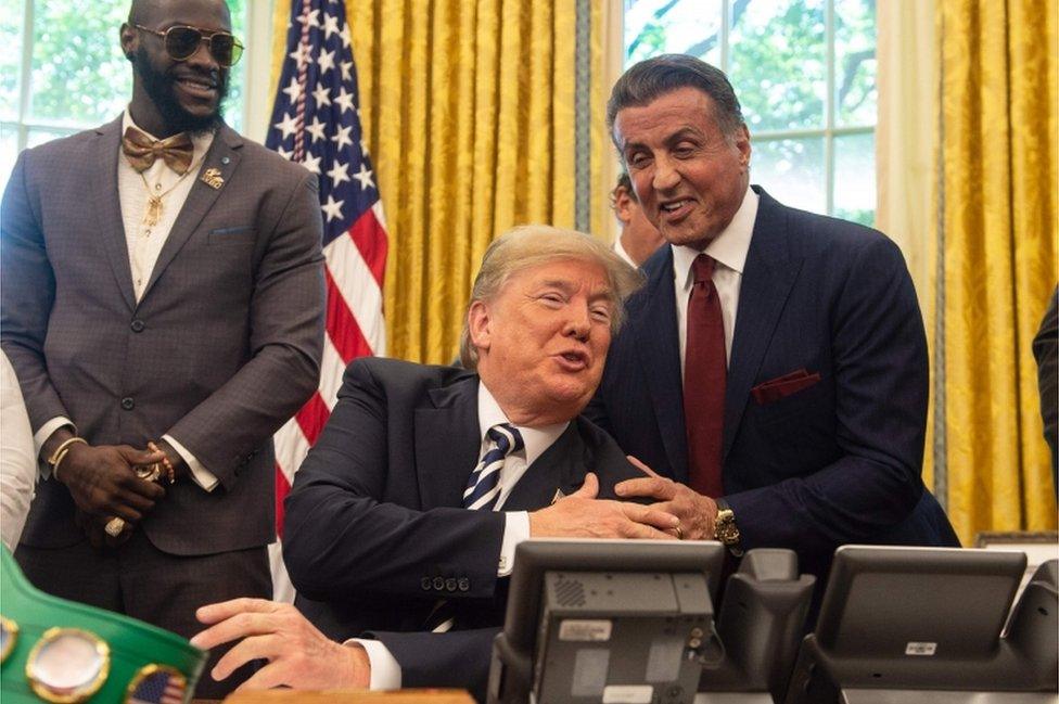 Actor Sylvester Stallone (right) and boxer Deontay Wilder (left) were present for the pardon signing.