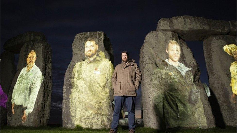 Stonehenge with faces on it.