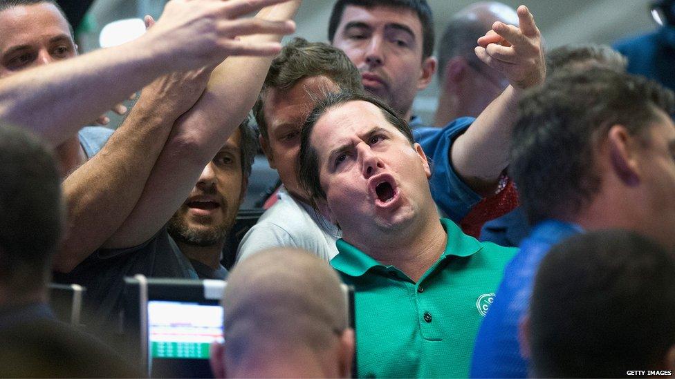 Traders signal offers in the Standard & Poor's 500 stock index options pit at the Chicago Board Options Exchange (CBOE) in Chicago, Illinois (24 Aug 2015)