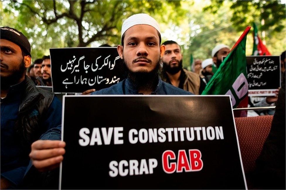 Demonstrators display placards to protest against the government's Citizenship Amendment Bill (CAB) in New Delhi on December 10, 2019