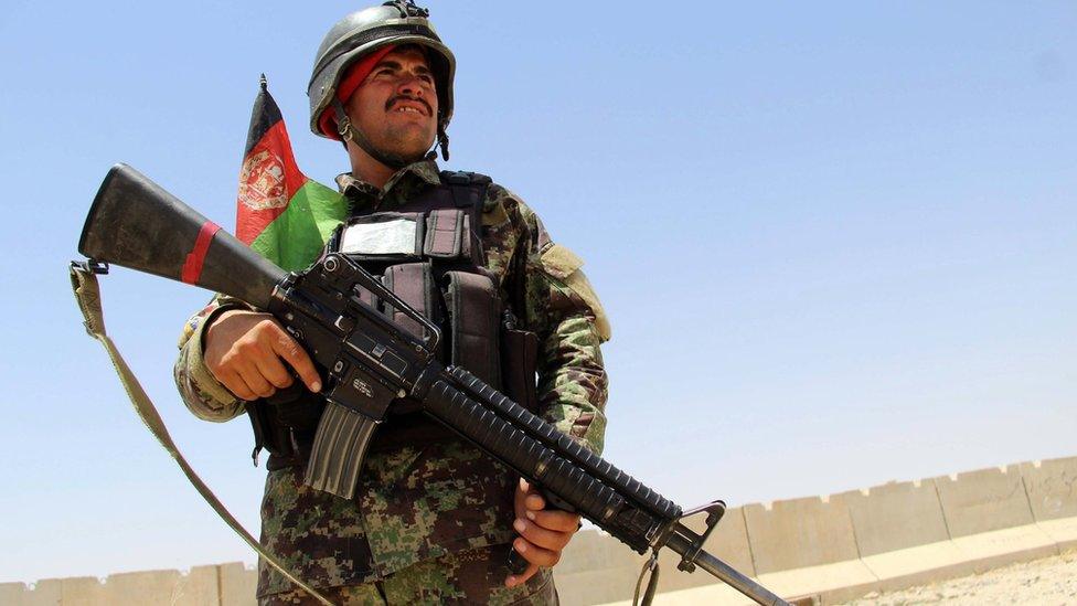 Afghan soldier secures a military base after overnight clashes with Taliban militants in Khakriz district, Kandahar, Afghanistan, 26 July 2017