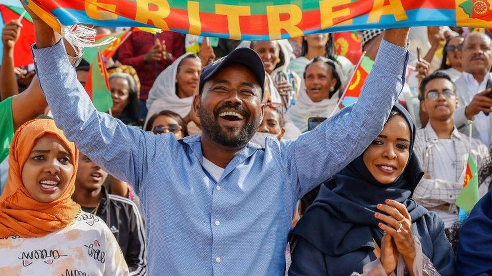 Attendees of the official 32nd Anniversary of Independence celebration wave flags and dance during the celebration at Asmara Stadium on May 24, 2023 in Asmara, Eritrea