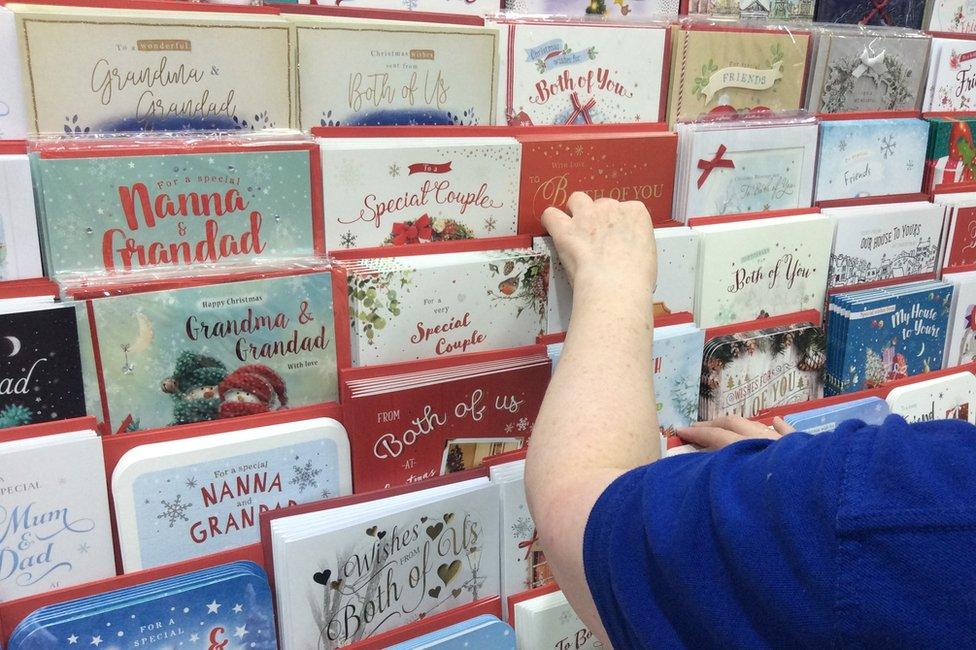 Shop manager sorting Christmas cards in Card Factory