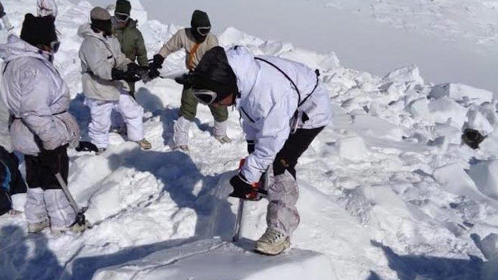 A undated handout photograph released by the Indian Defense Ministry on 09 February 2016 shows rescuers searching for survivors after an avalanche at Siachen, India.