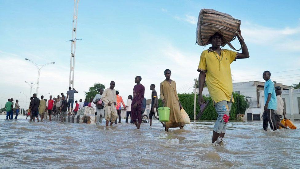 People walking through a flooded street in Maiduguri, Nigeria - September 2024